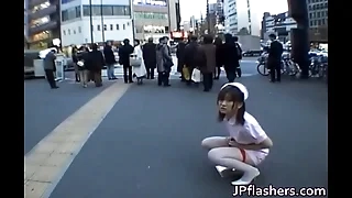 Naughty Asian girl is pissing in check up by public